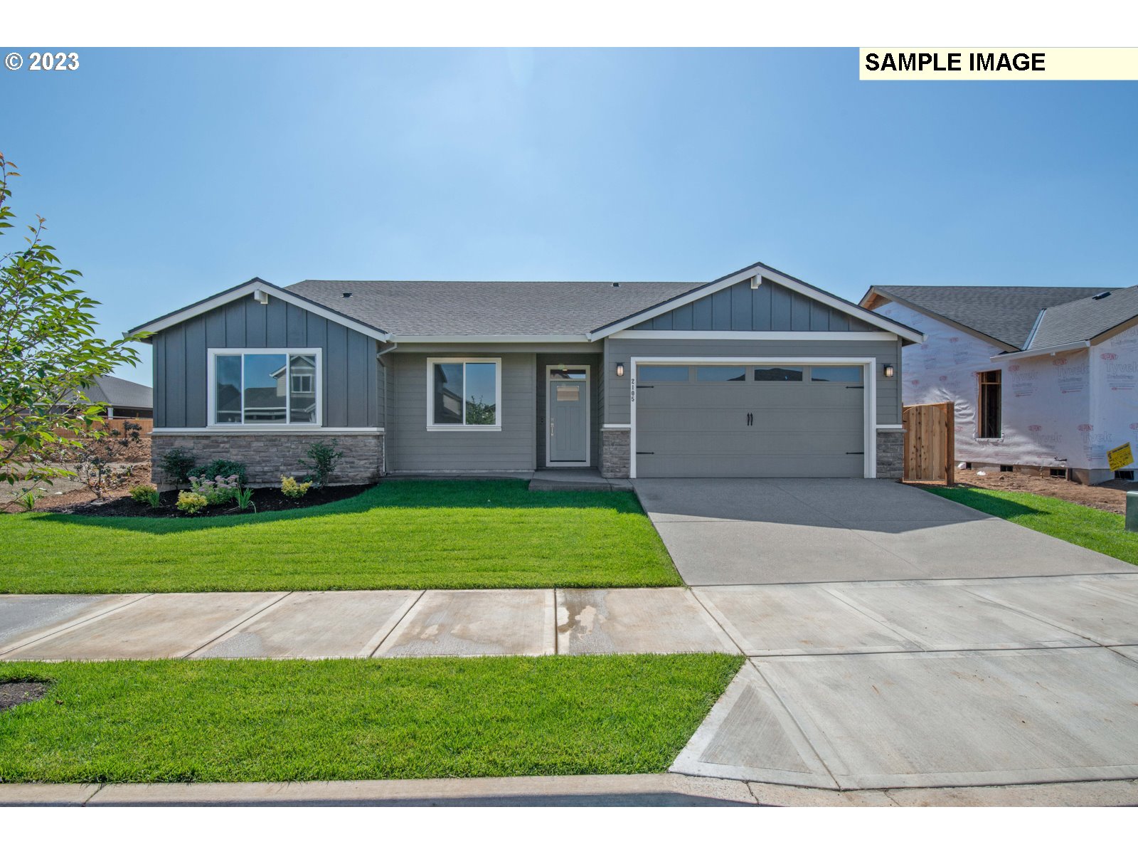 8853 North 5th Street, Unit 62 Ridgefield, WA 98642 - Photo 1 of 27 a front view of a house with a yard and garage