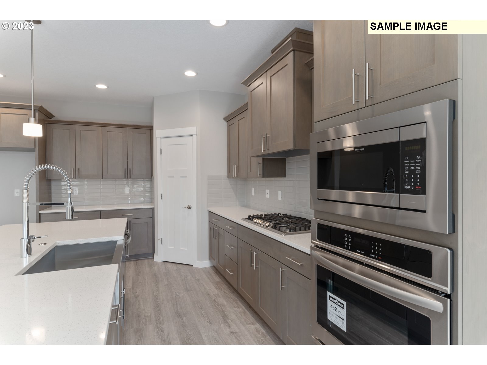 8853 North 5th Street, Unit 62 Ridgefield, WA 98642 - Photo 3 of 27 a kitchen with granite countertop a sink cabinets and stainless steel appliances