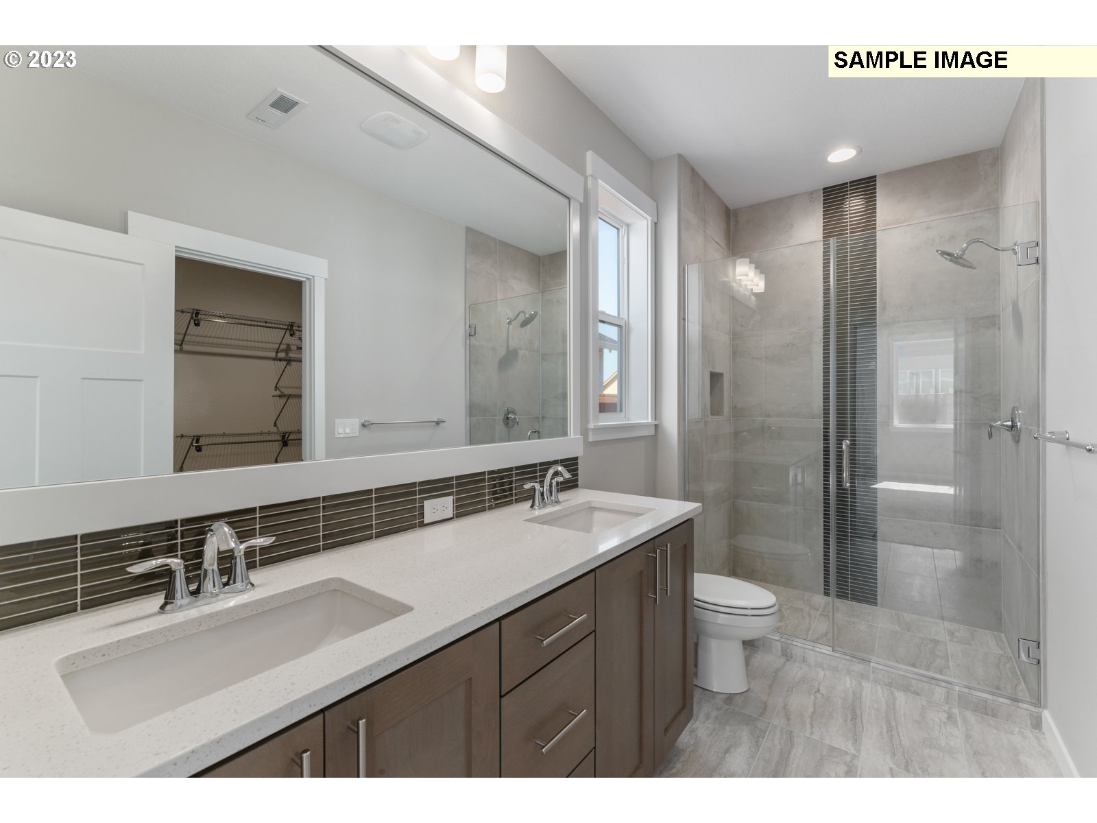8853 North 5th Street, Unit 62 Ridgefield, WA 98642 - Photo 10 of 27 a bathroom with a sink double vanity granite toilet and a shower