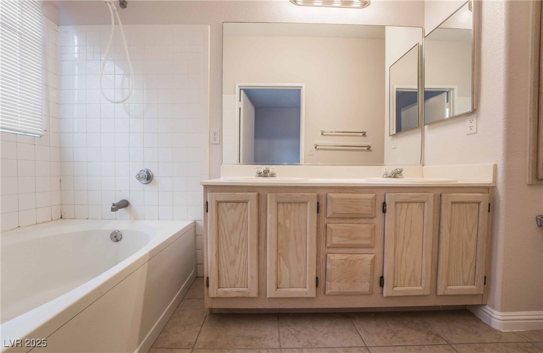 5415 West Harmon Avenue, Unit 1162 Las Vegas, NV 89103 - Photo 11 of 21 Full bath with double vanity and light tile patterned floors