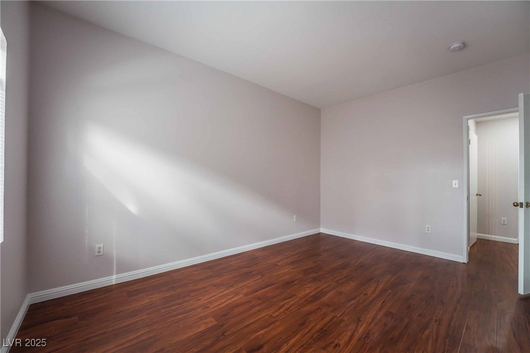5415 West Harmon Avenue, Unit 1162 Las Vegas, NV 89103 - Photo 14 of 21 Unfurnished room with dark wood-style floors