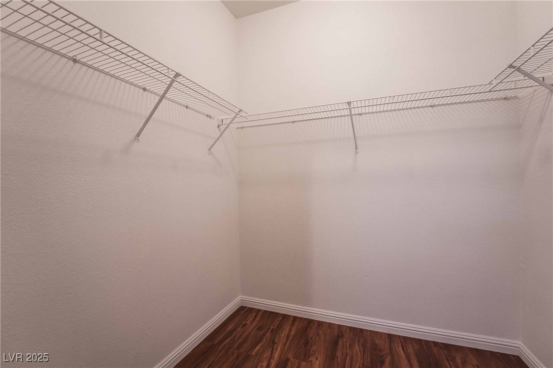 5415 West Harmon Avenue, Unit 1162 Las Vegas, NV 89103 - Photo 18 of 21 Spacious closet with dark wood-style floors