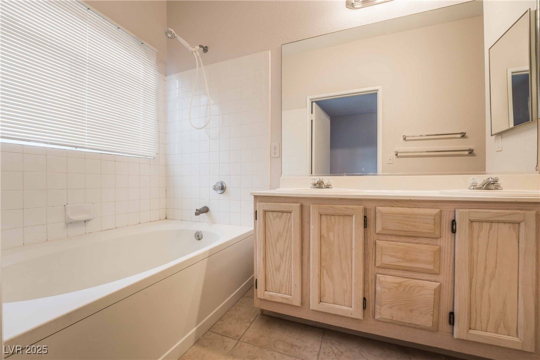 5415 West Harmon Avenue, Unit 1162 Las Vegas, NV 89103 - Photo 10 of 21 Bathroom featuring double vanity, shower combination, and light tile patterned flooring