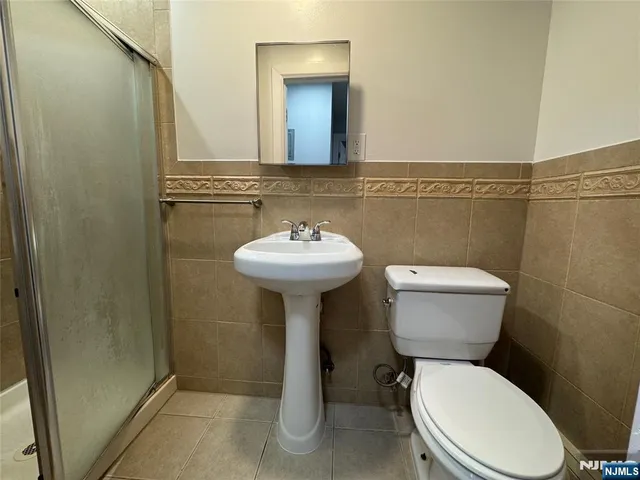 a bathroom with a sink mirror and toilet
