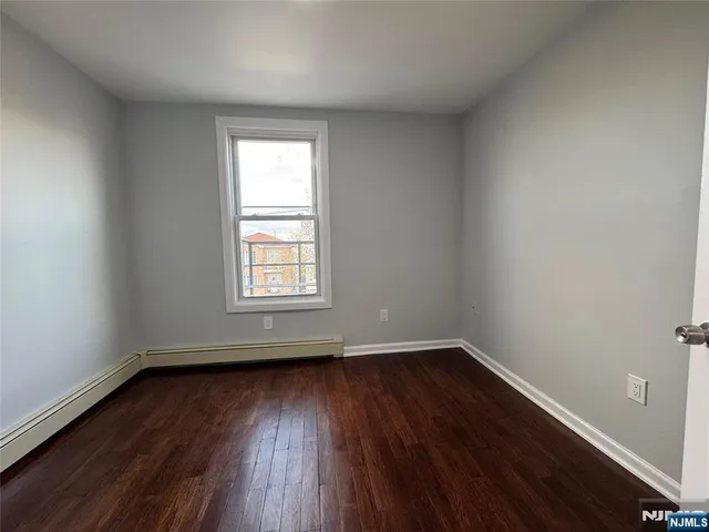 wooden floor and window in an empty room