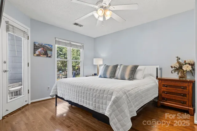 a bedroom with a bed a chandelier and a table
