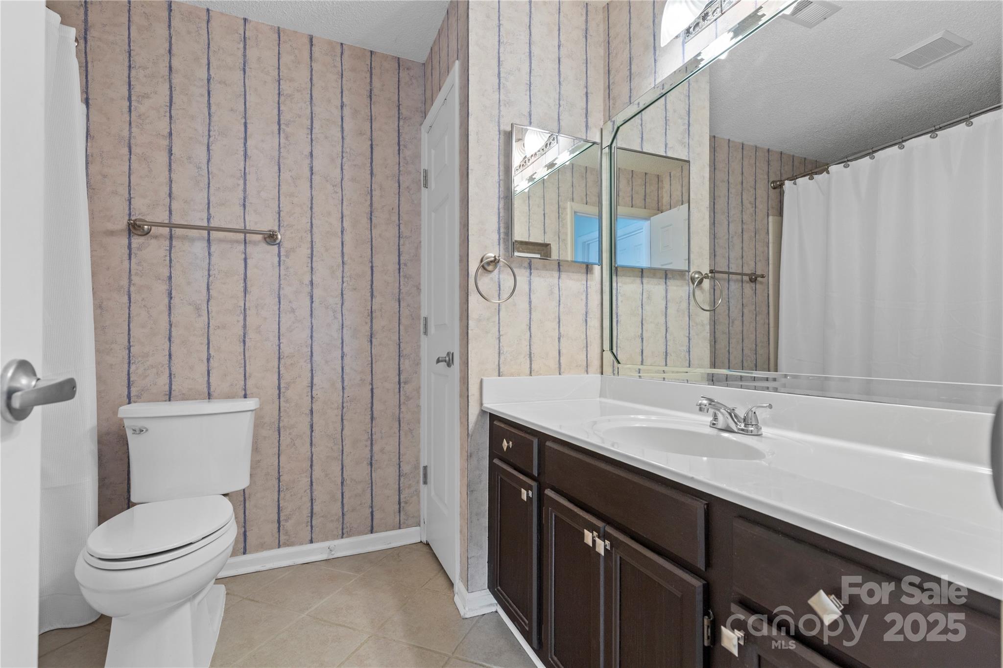 719 Southwest Drive Davidson, NC 28036 - Photo 13 of 27 a bathroom with a sink a toilet and shower