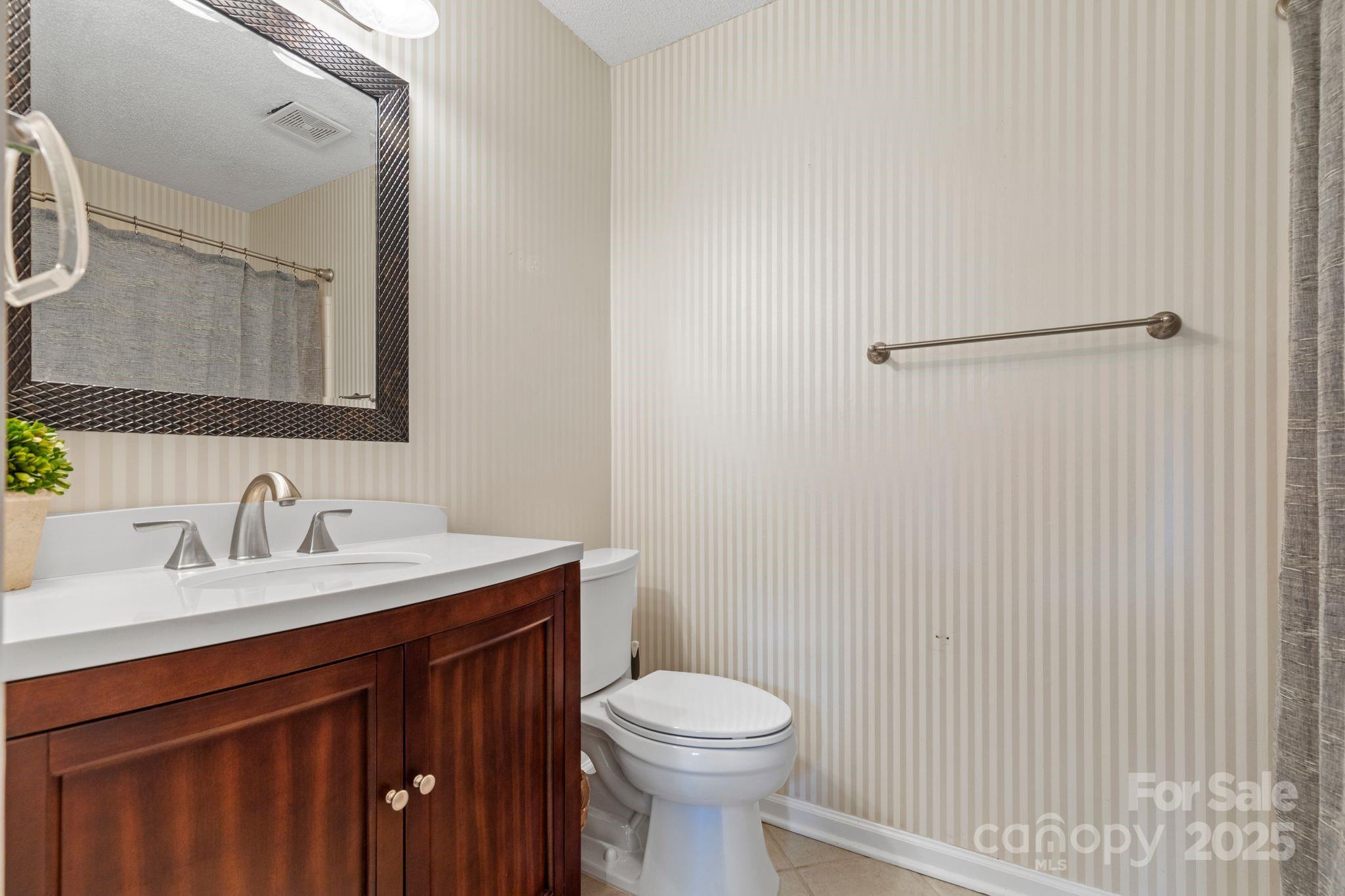 719 Southwest Drive Davidson, NC 28036 - Photo 17 of 27 a bathroom with a sink vanity mirror and toilet
