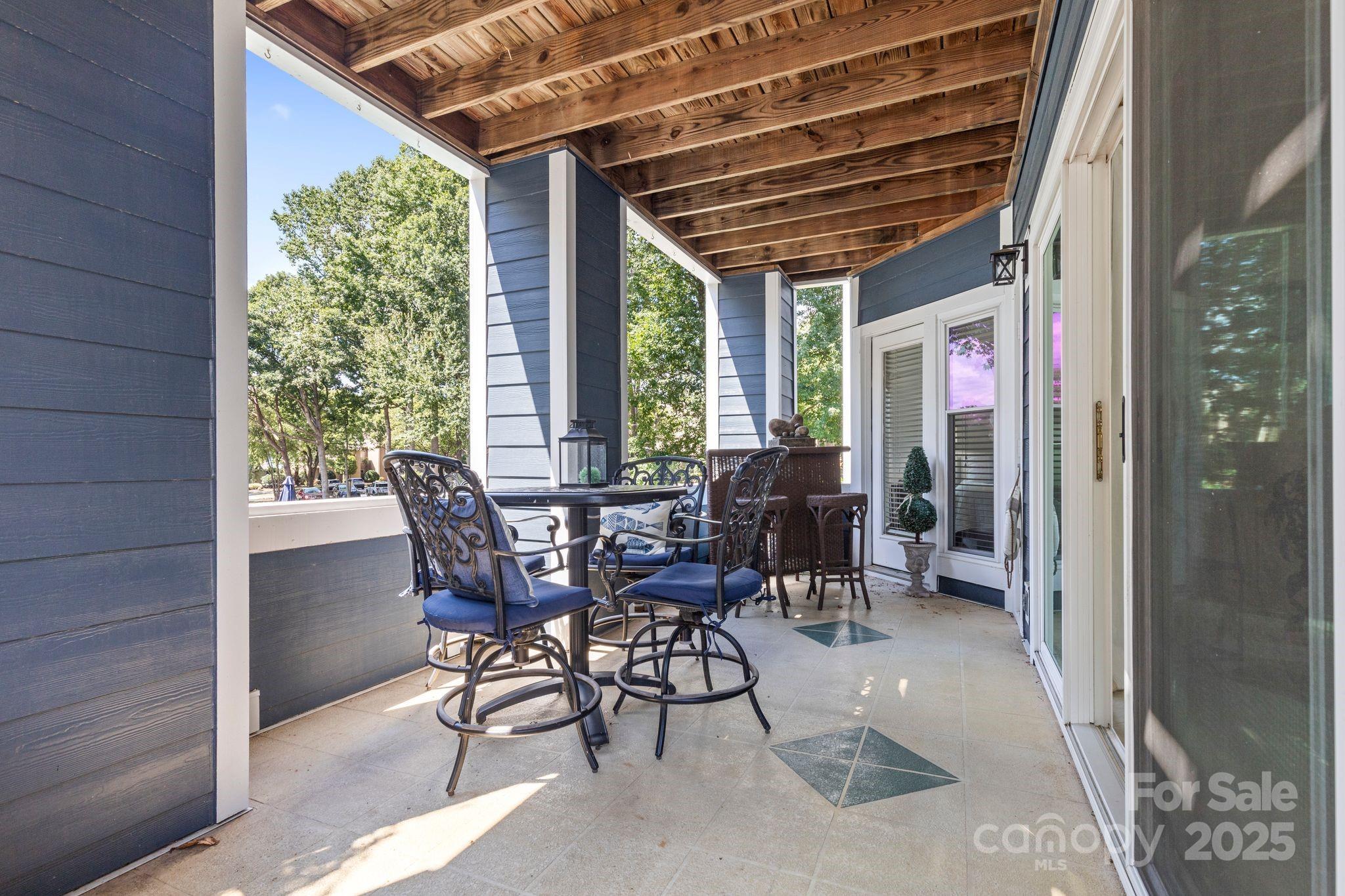 719 Southwest Drive Davidson, NC 28036 - Photo 18 of 27 a view of a patio with table and chairs and potted plants