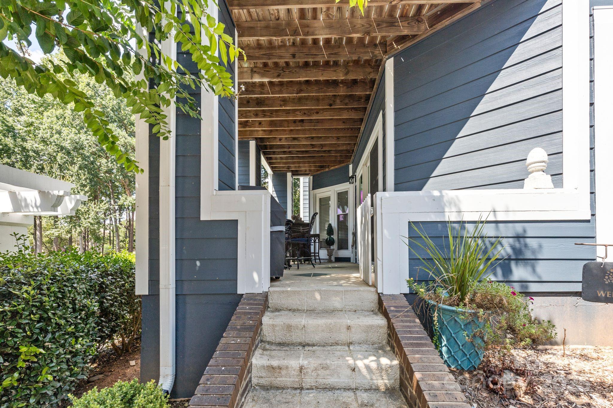 719 Southwest Drive Davidson, NC 28036 - Photo 19 of 27 a view of a pathway of house with potted plants