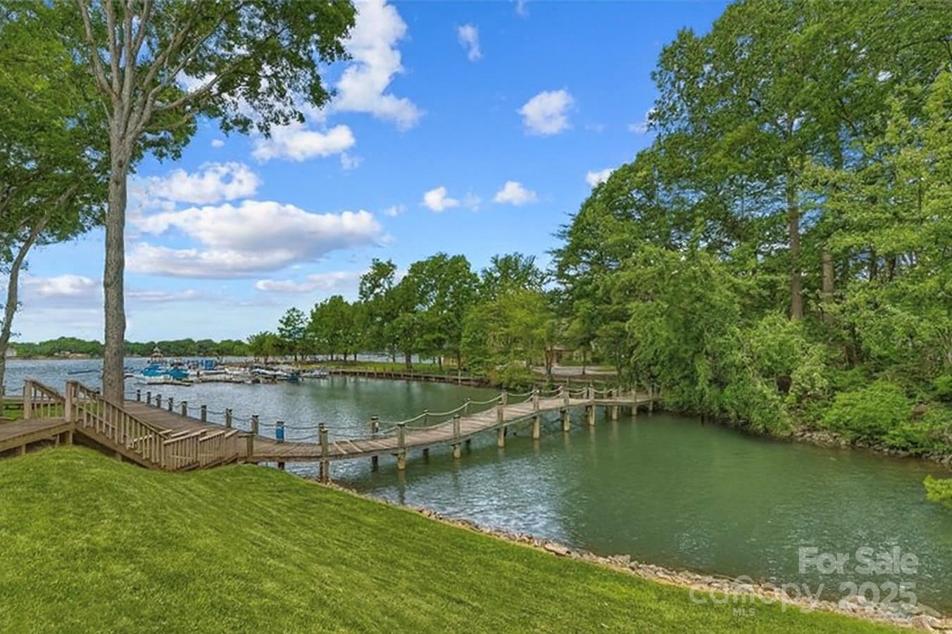 719 Southwest Drive Davidson, NC 28036 - Photo 3 of 27 a view of a lake with a garden