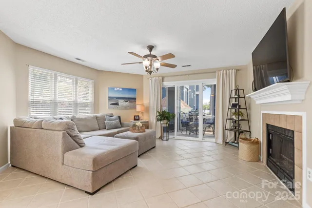 a living room with furniture and kitchen view