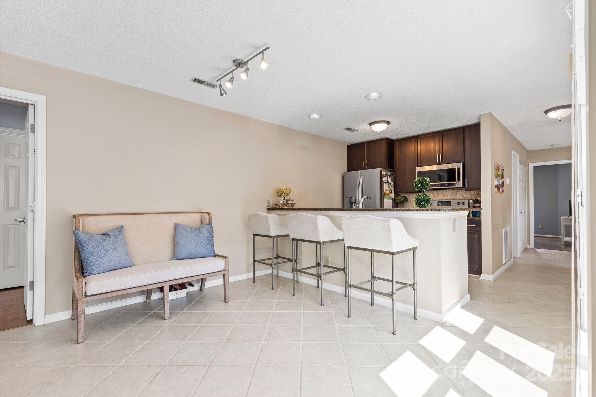 719 Southwest Drive Davidson, NC 28036 - Photo 8 of 27 a living room with furniture and kitchen view