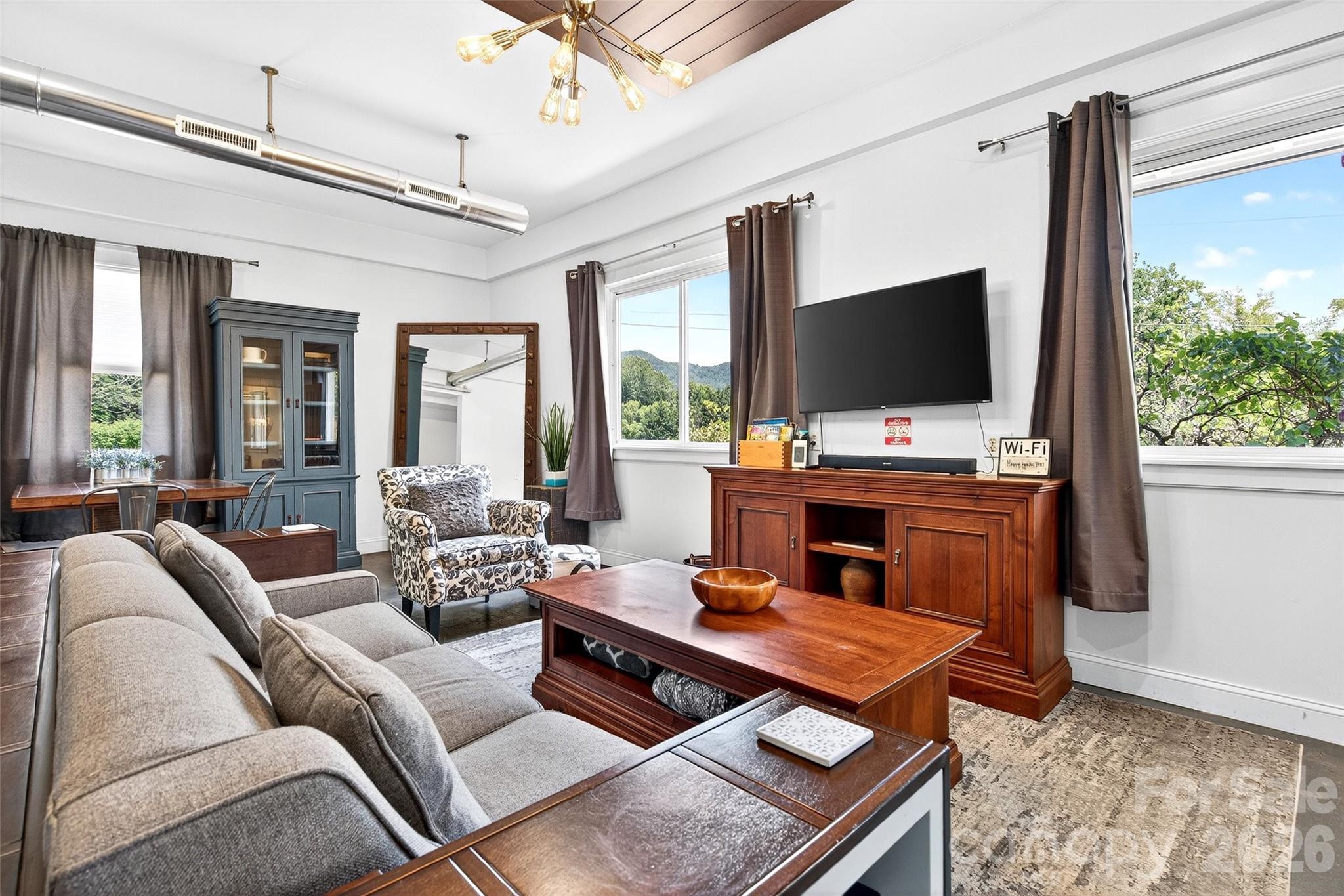 a living room with furniture and a flat screen tv
