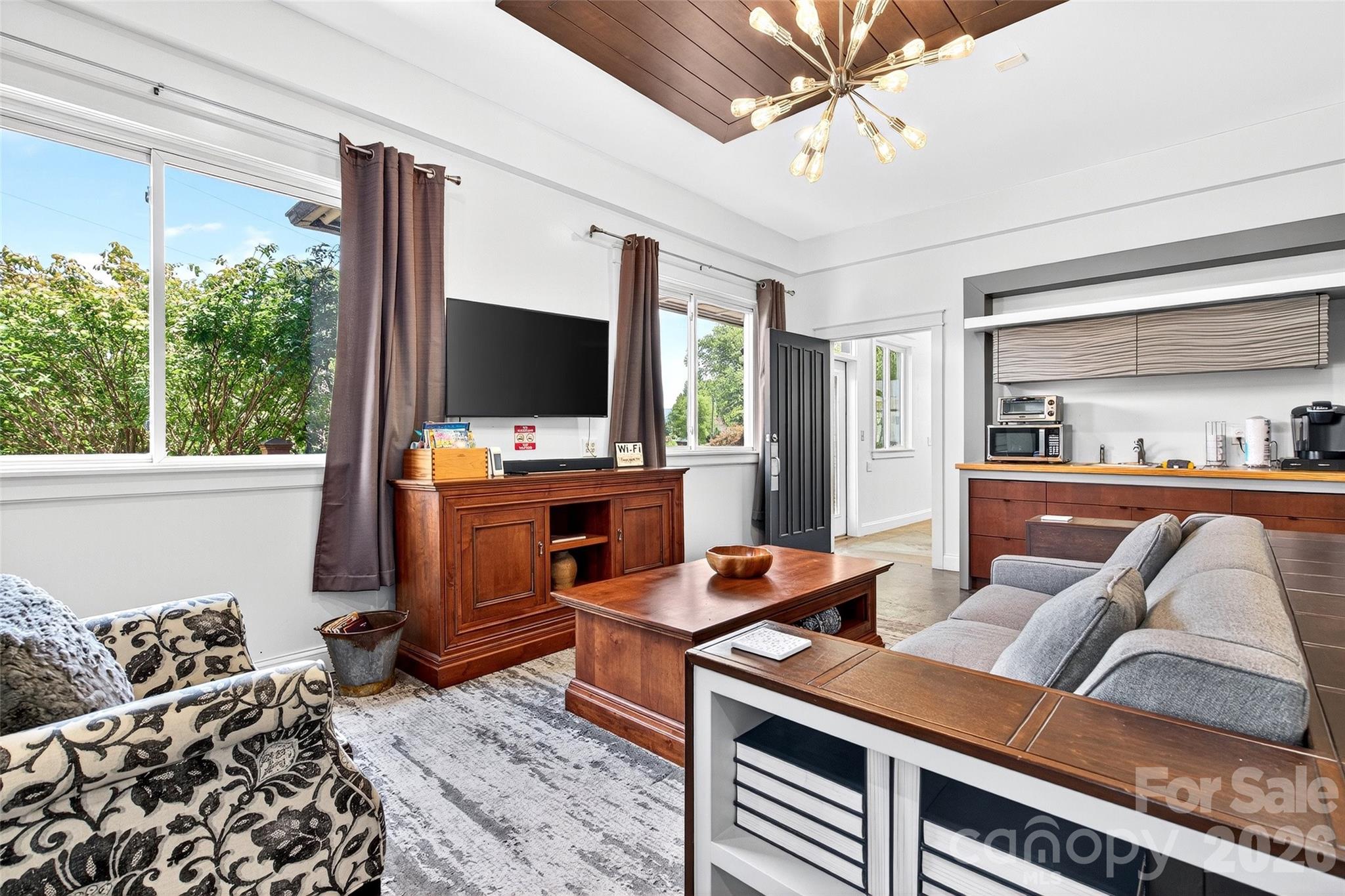 626 Old Lytle Cove Road Swannanoa, NC 28778 - Photo 15 of 48 a workspace with furniture and a flat screen tv