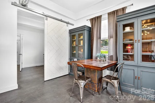 a dining room with furniture and window