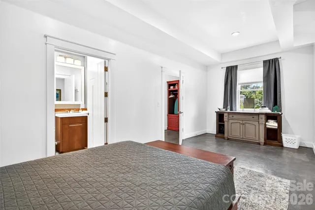 a bedroom with a bed and a view of kitchen