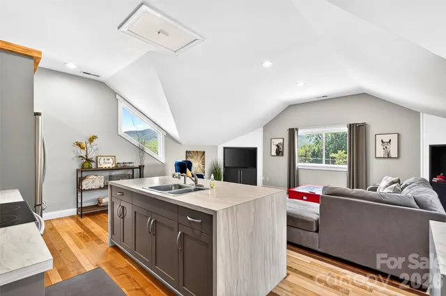 a kitchen with kitchen island a refrigerator stove and microwave