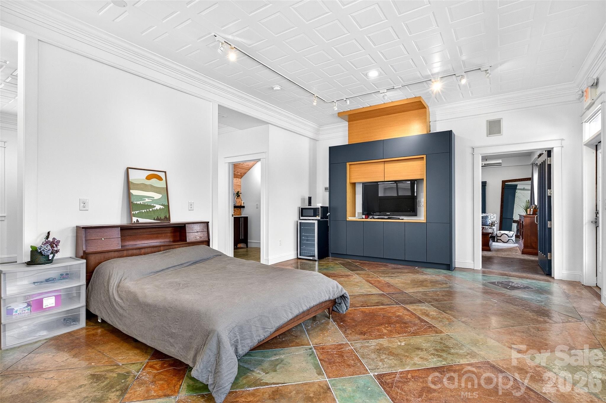 626 Old Lytle Cove Road Swannanoa, NC 28778 - Photo 10 of 48 a bedroom with a bed and a flat screen tv