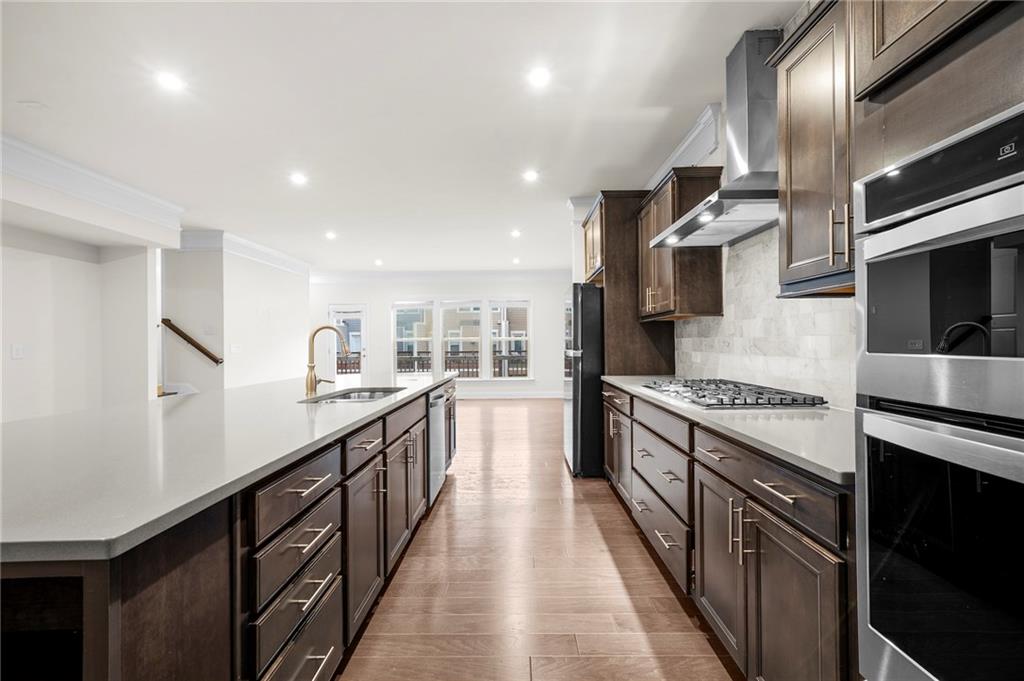 2166 Rock Creek Park Decatur, GA 30033 - Photo 13 of 40 a large kitchen with stainless steel appliances granite countertop lots of counter space and wooden floor