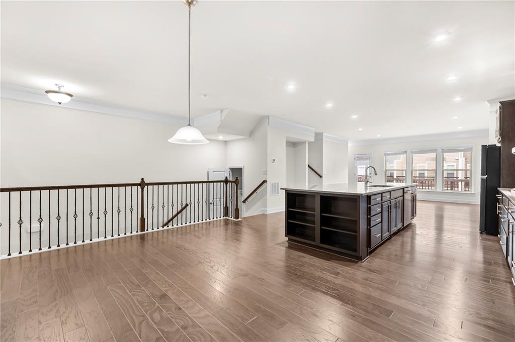 2166 Rock Creek Park Decatur, GA 30033 - Photo 15 of 40 a view of a kitchen with kitchen island wooden floor and a chandelier
