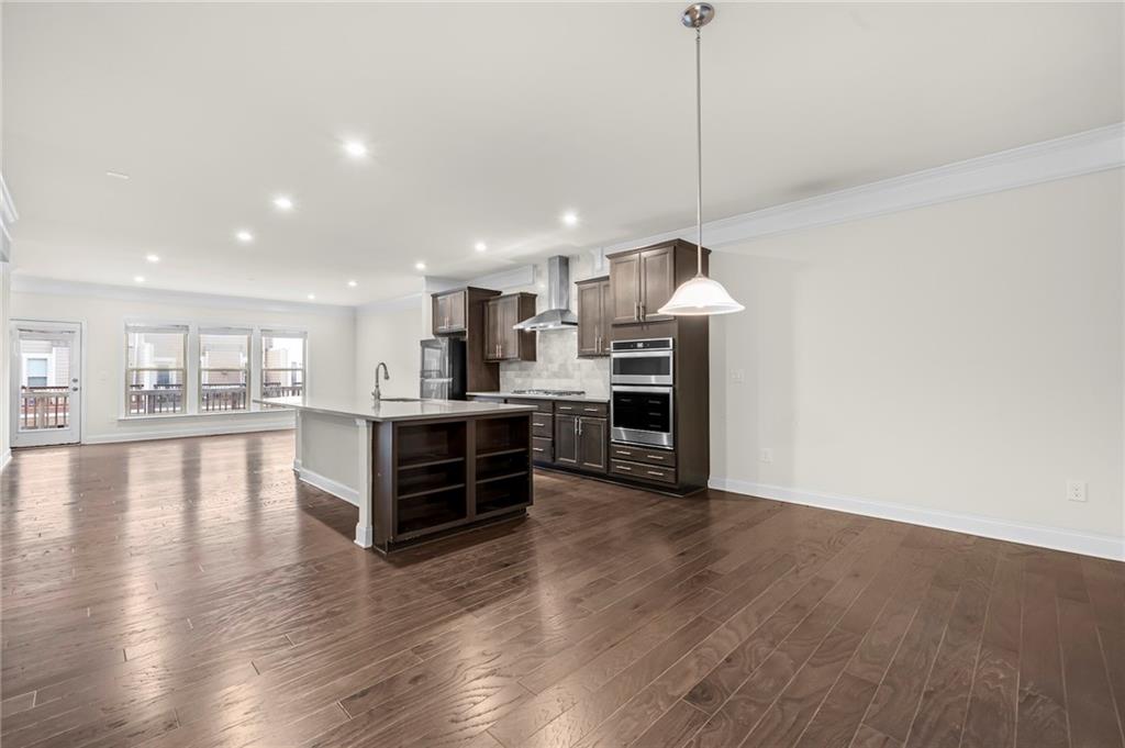 2166 Rock Creek Park Decatur, GA 30033 - Photo 16 of 40 a large kitchen with stainless steel appliances granite countertop a large counter top a sink and a wooden floors
