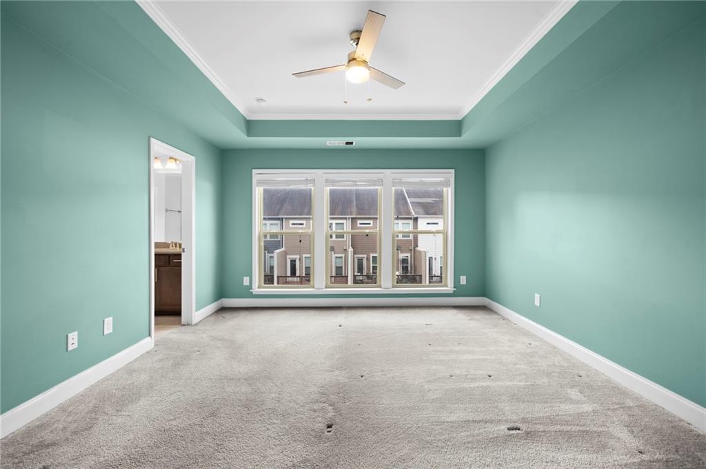 2166 Rock Creek Park Decatur, GA 30033 - Photo 23 of 40 an empty room with chandelier fan and windows