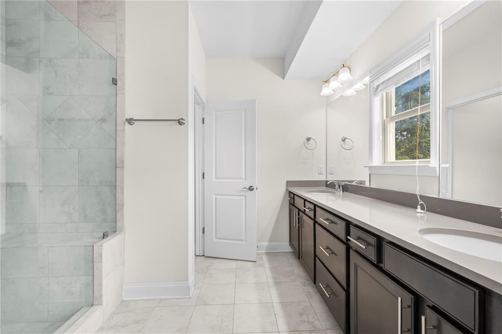 2166 Rock Creek Park Decatur, GA 30033 - Photo 27 of 40 a spacious bathroom with a granite countertop sink a mirror and a