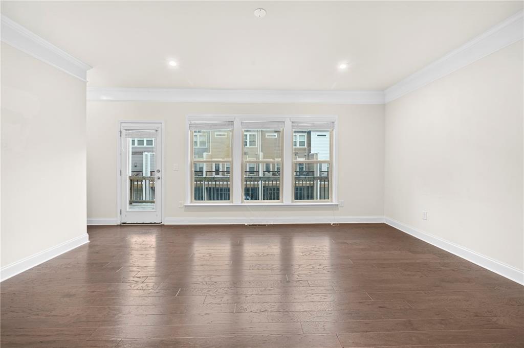 2166 Rock Creek Park Decatur, GA 30033 - Photo 6 of 40 a view of an empty room with wooden floor and a window