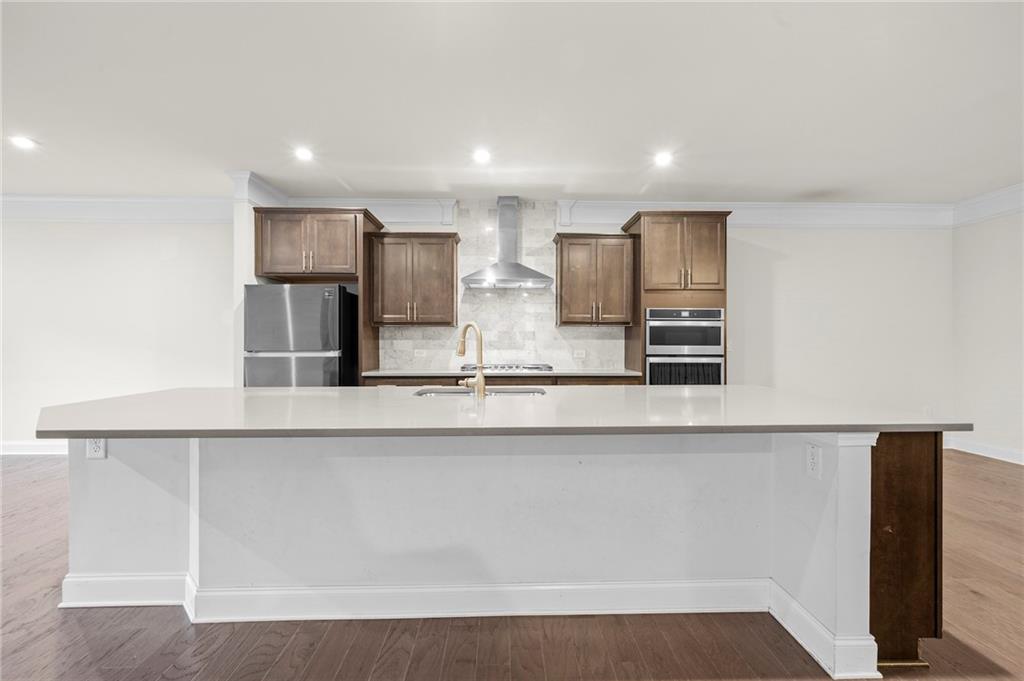 2166 Rock Creek Park Decatur, GA 30033 - Photo 10 of 40 a large kitchen with stainless steel appliances a large counter top and wooden cabinets