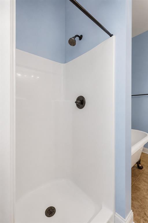 179 Ranchtown Road Elm Grove, LA 71051 - Photo 11 of 26 White shower stall with oil-rubbed bronze fixtures and a dark shower rod, set against a light blue wall