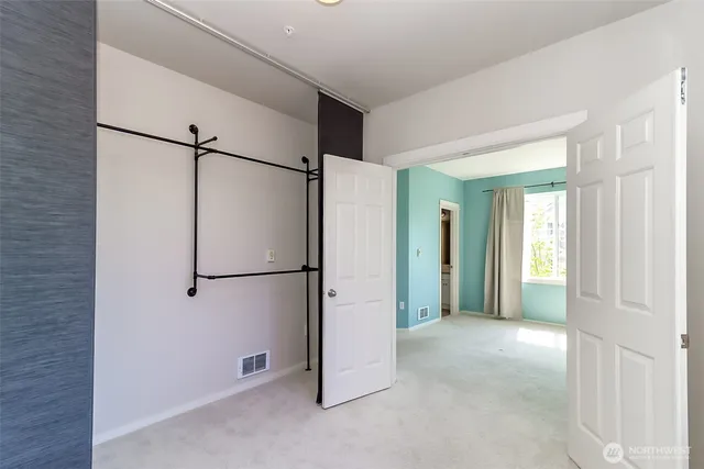 a bathroom with a granite countertop sink a toilet a mirror and shower