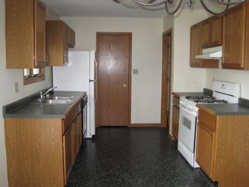 330 9th Avenue, Unit 330 Rochelle, IL 61068 - Photo 3 of 13 a kitchen with a sink a stove and a refrigerator