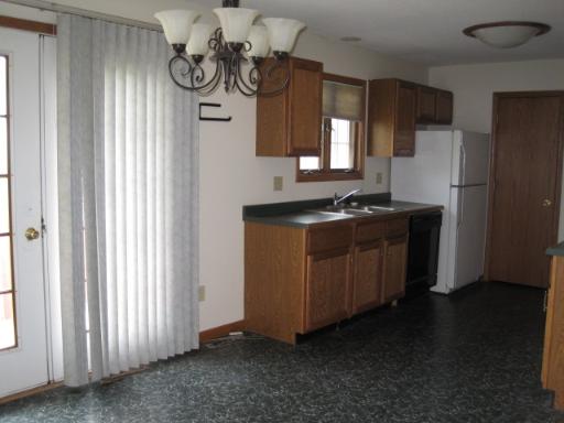 330 9th Avenue, Unit 330 Rochelle, IL 61068 - Photo 4 of 13 a kitchen with stainless steel appliances granite countertop a sink a stove and a refrigerator