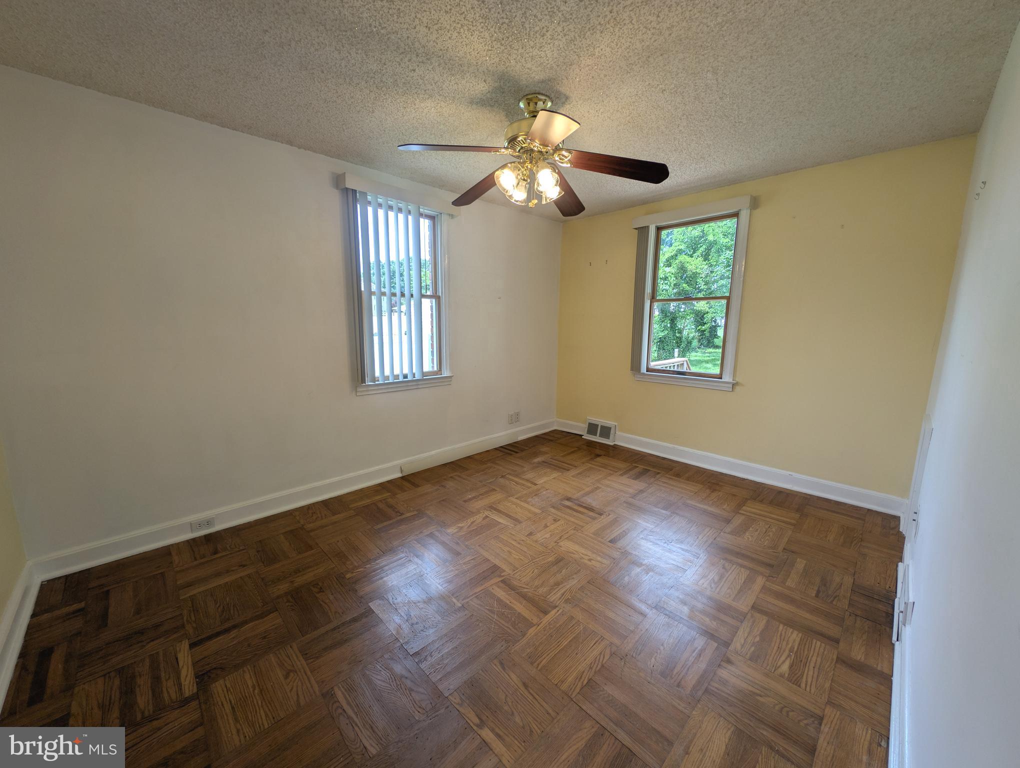 1129 Providence Road Springfield, PA 19064 - Photo 7 of 15 a view of an empty room with wooden floor and a window