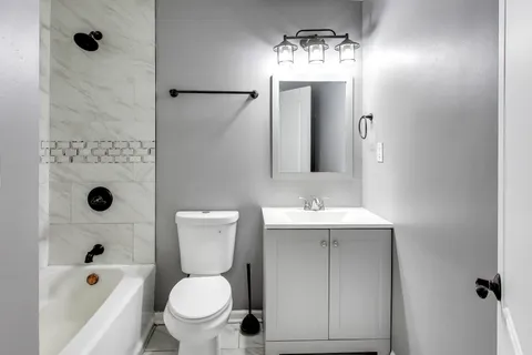 a bathroom with a sink toilet and shower