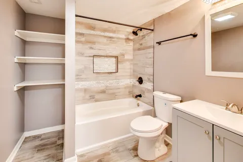 a bathroom with a toilet sink and shower