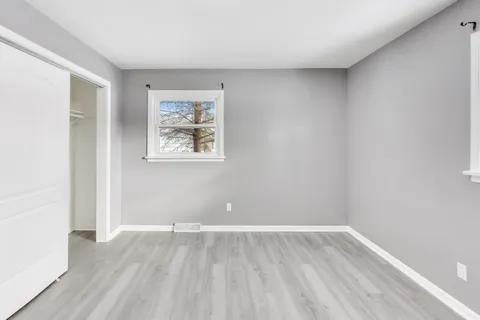 wooden floor in an empty room with a window
