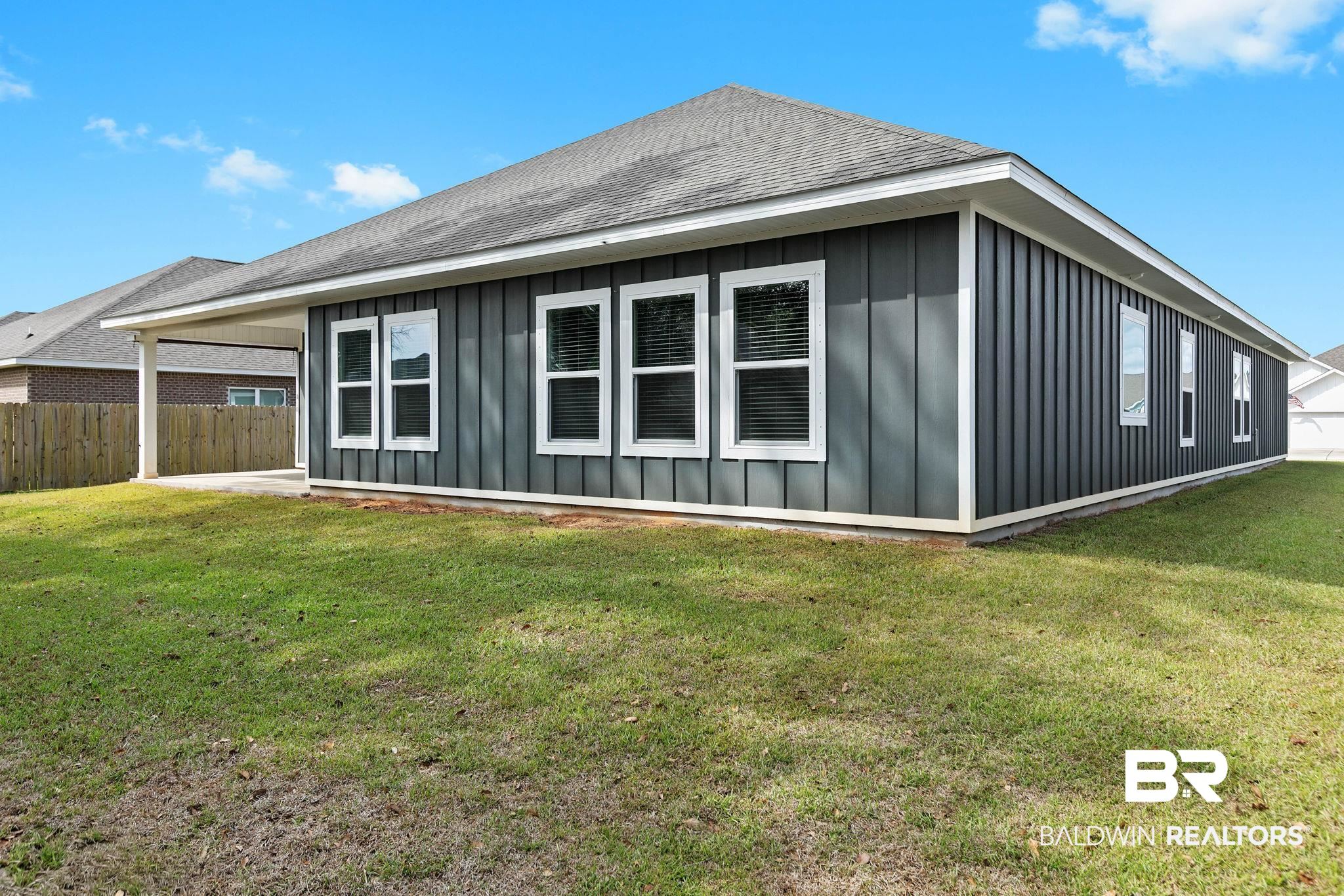 9448 Amethyst Drive Daphne, AL 36526 - Photo 57 of 61 View of side of home with board and batten siding and roof with shingles