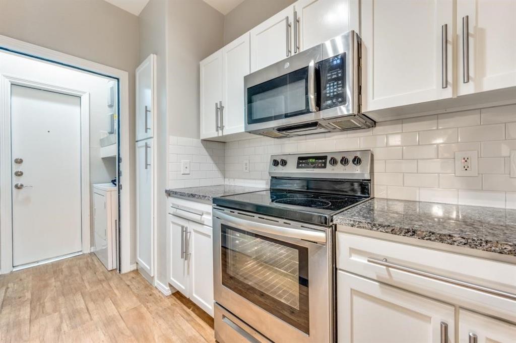 330 Las Colinas Boulevard East, Unit 140 Irving, TX 75039 - Photo 1 of 14 a kitchen with granite countertop a stove and a microwave