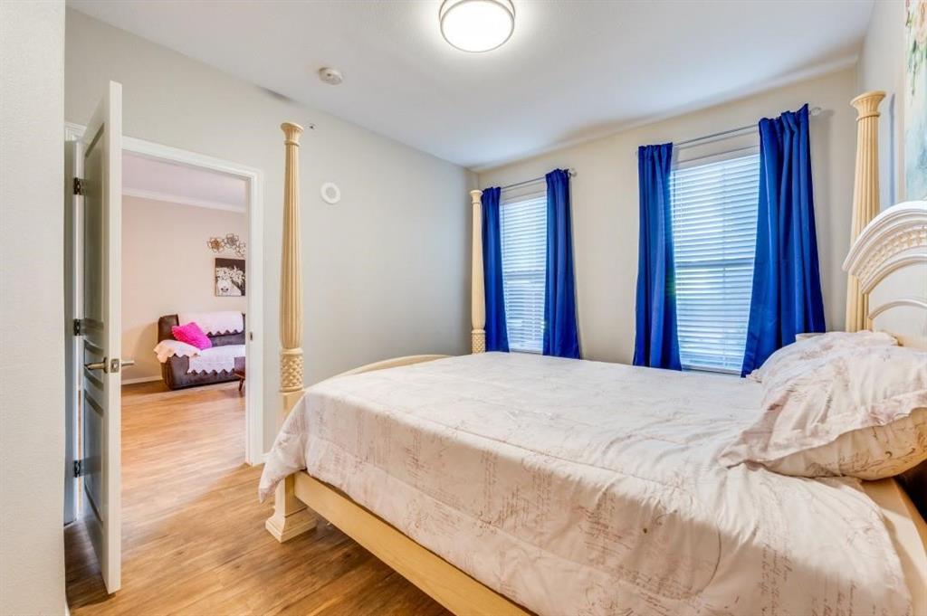 330 Las Colinas Boulevard East, Unit 140 Irving, TX 75039 - Photo 5 of 14 a bedroom with a bed and a chandelier