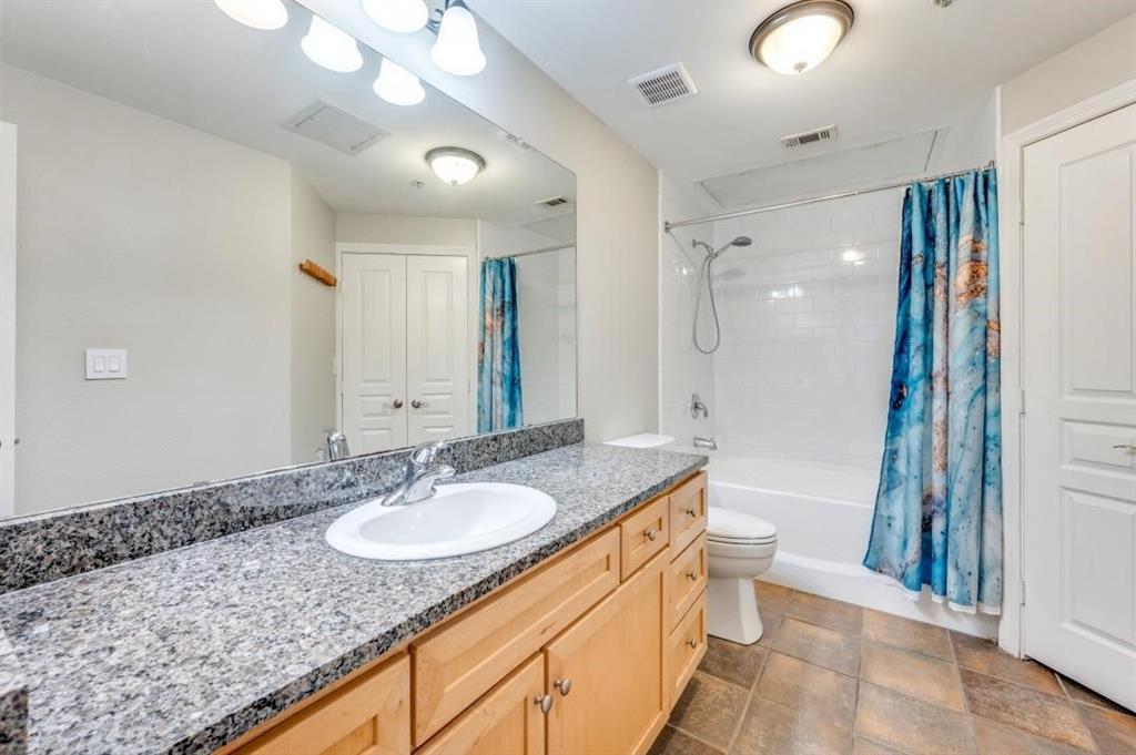 330 Las Colinas Boulevard East, Unit 140 Irving, TX 75039 - Photo 6 of 14 a bathroom with a granite countertop sink a toilet a mirror and shower