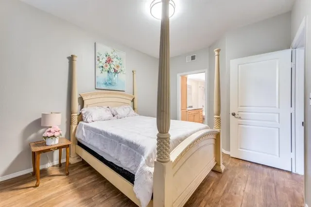 a bedroom with a bed and a painting on the wall