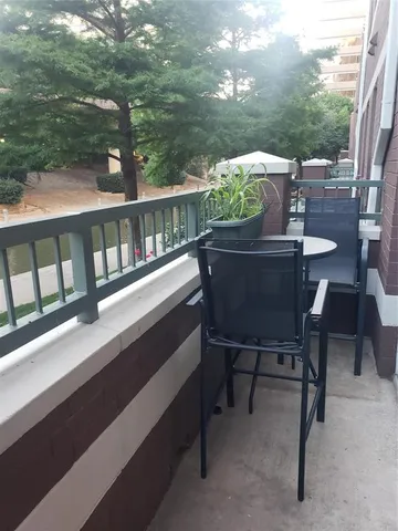 a view of a chairs and table in the balcony