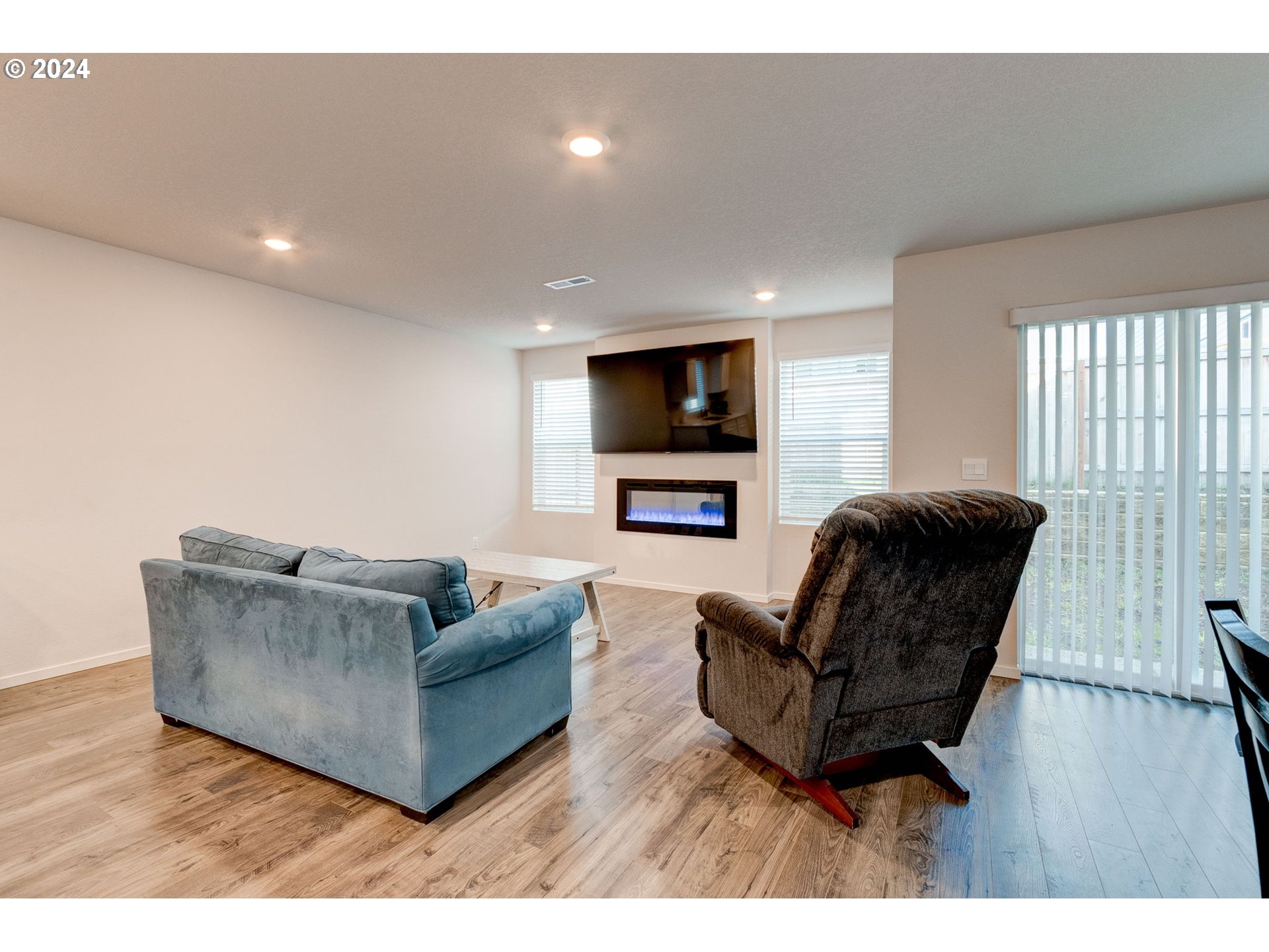 236 Northeast 28th Court Ridgefield, WA 98642 - Photo 5 of 22 a living room with furniture and a flat screen tv