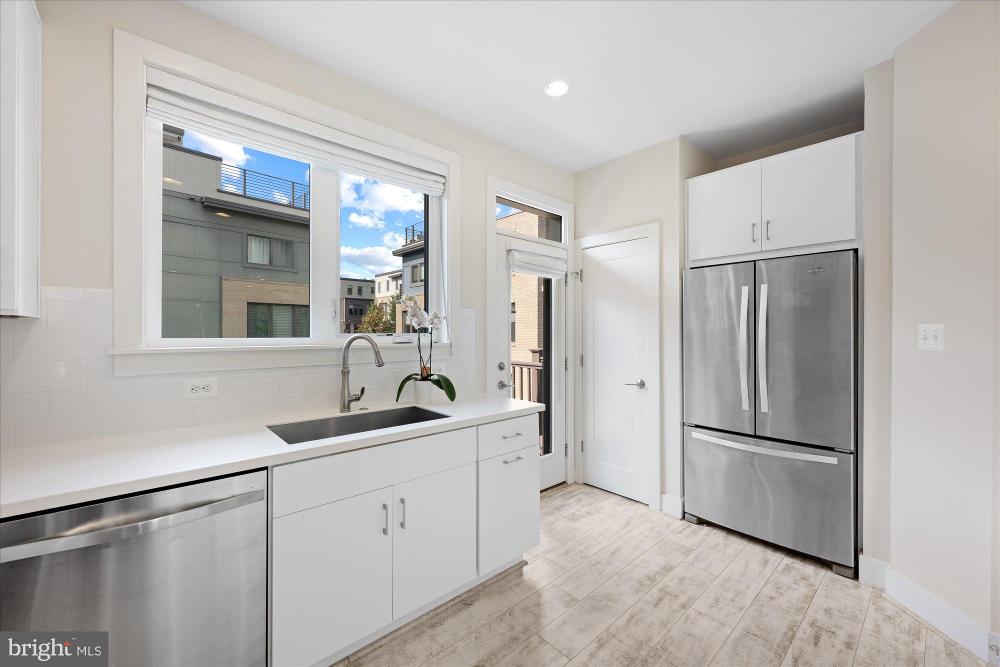 6597 Rock Spring Drive Bethesda, MD 20817 - Photo 12 of 37 a kitchen with a refrigerator and a sink