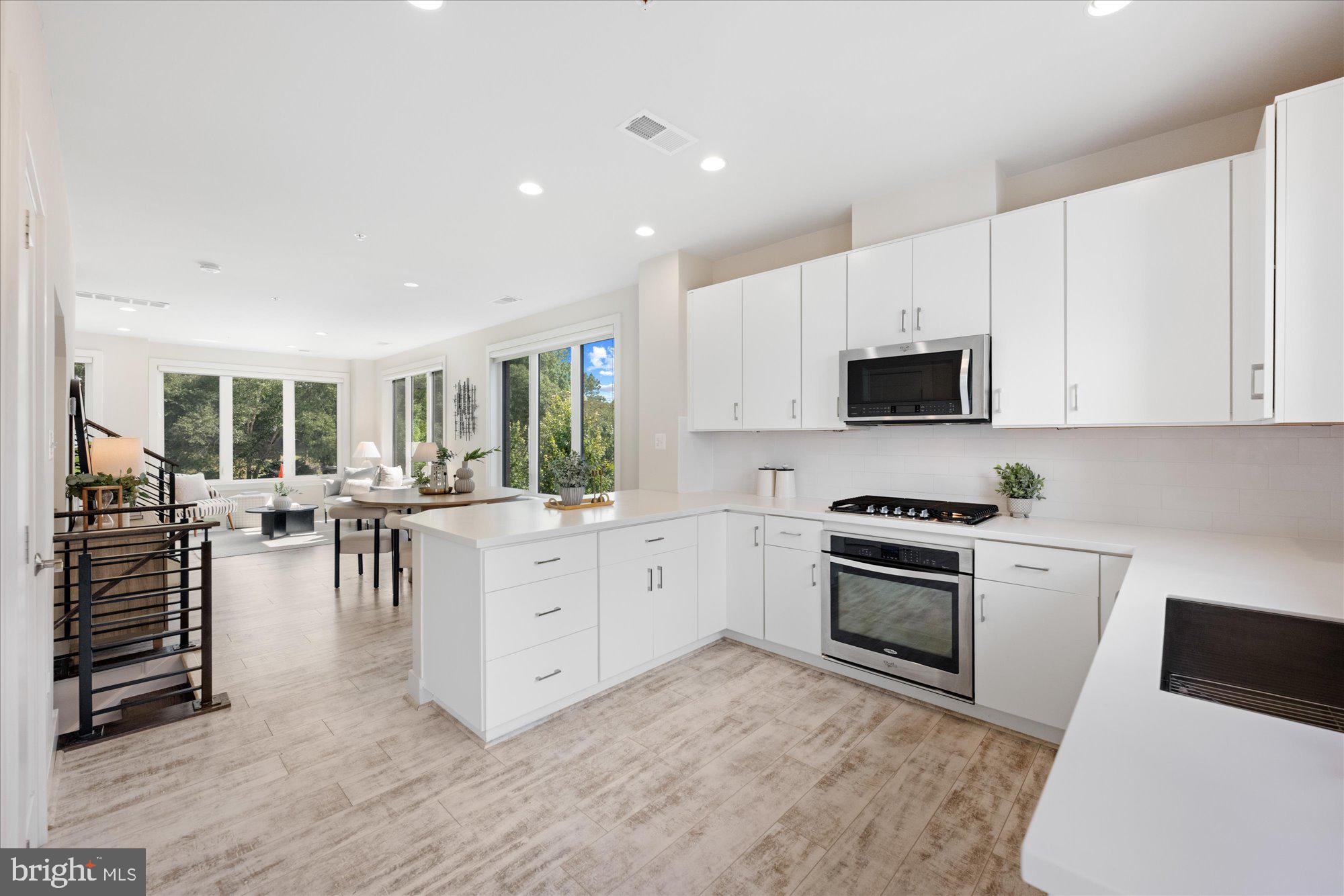 6597 Rock Spring Drive Bethesda, MD 20817 - Photo 13 of 37 a kitchen with white cabinets and appliances