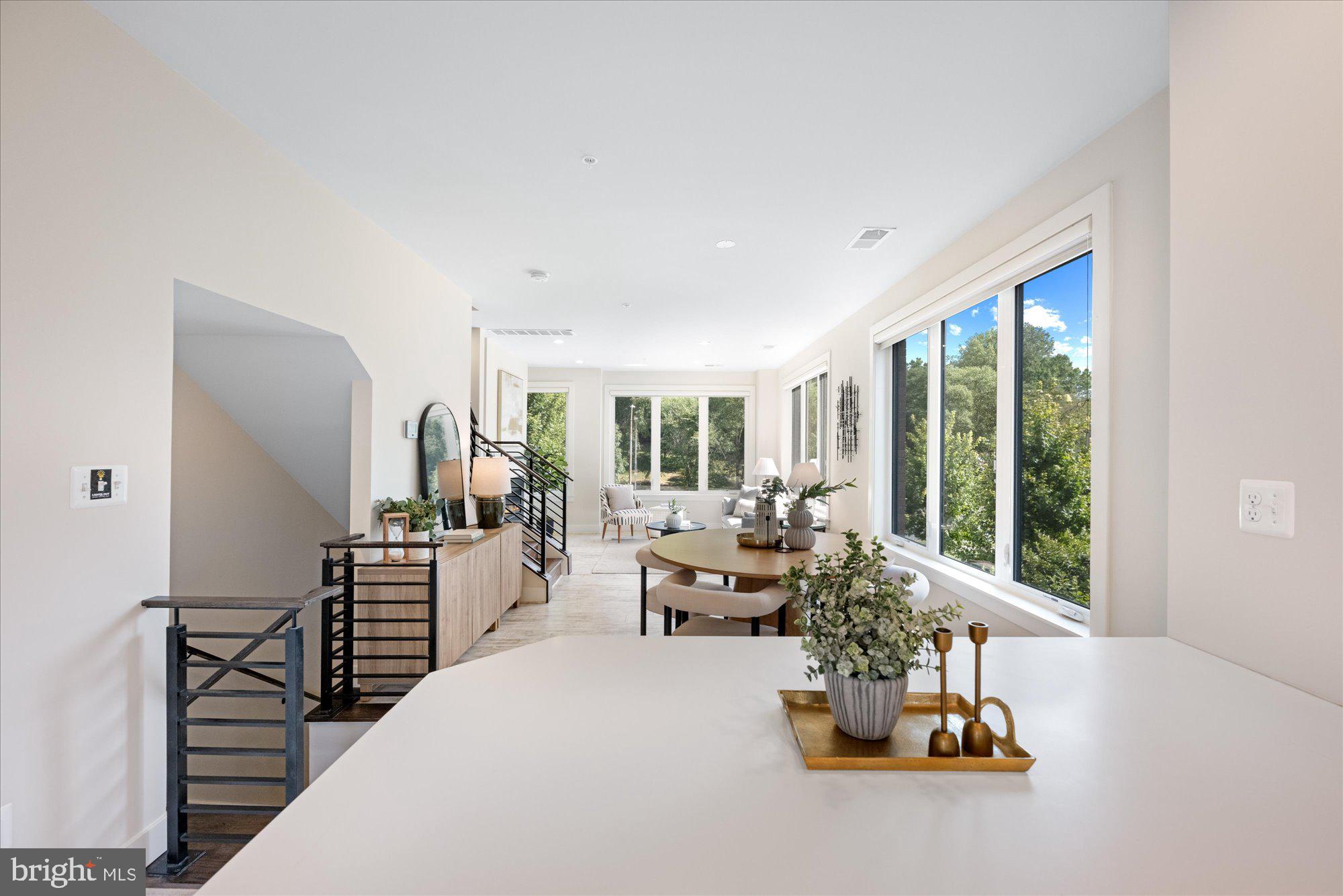 6597 Rock Spring Drive Bethesda, MD 20817 - Photo 16 of 37 a living room with furniture and large windows