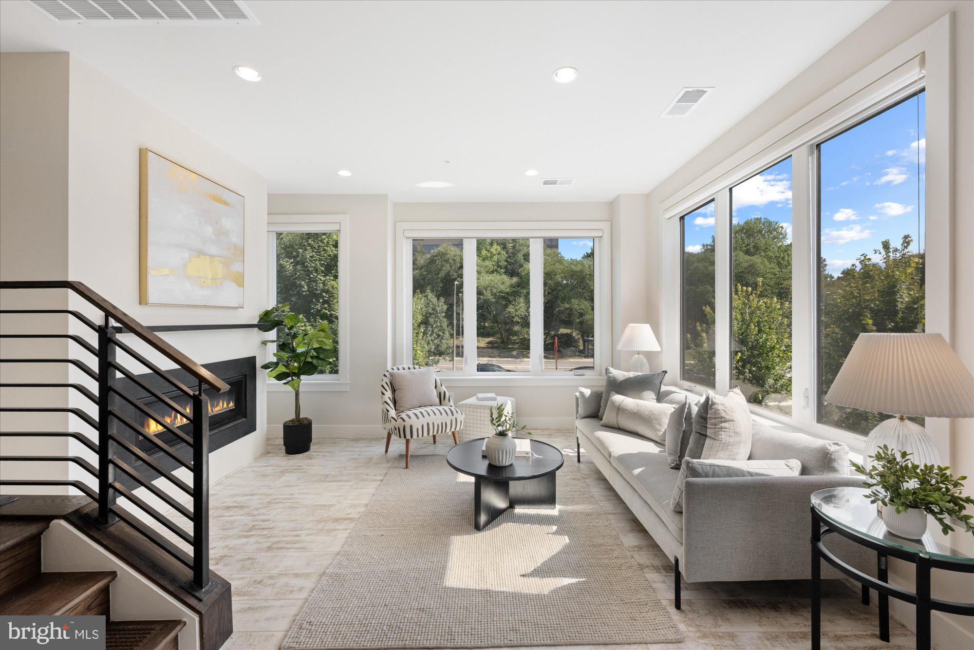 6597 Rock Spring Drive Bethesda, MD 20817 - Photo 19 of 37 a living room with furniture and floor to ceiling windows