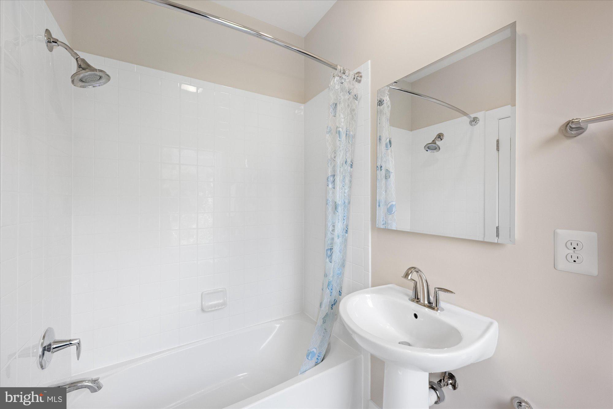 6597 Rock Spring Drive Bethesda, MD 20817 - Photo 29 of 37 a bathroom with a sink and a mirror